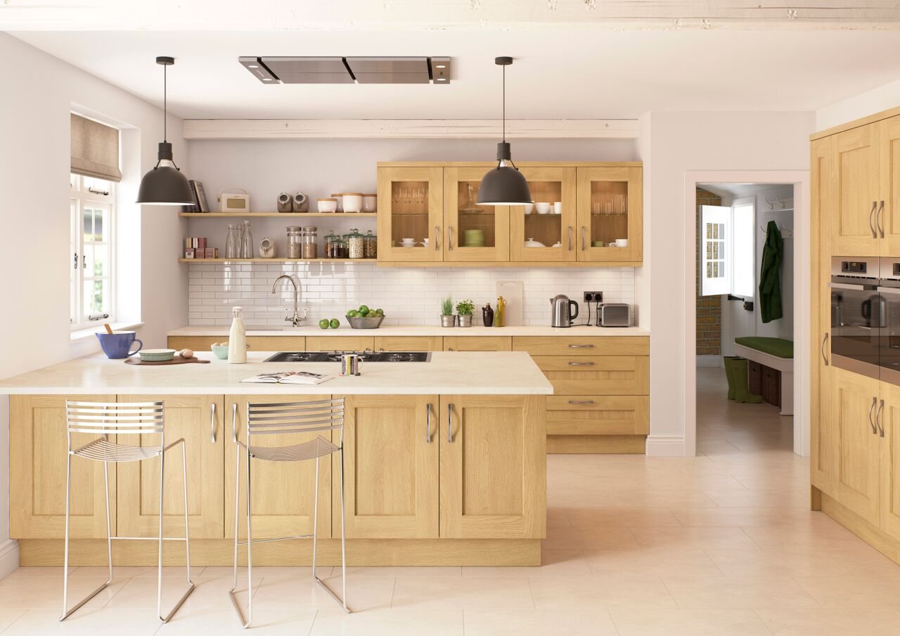 A light oak shaker kitchen with a central island and timber worktops