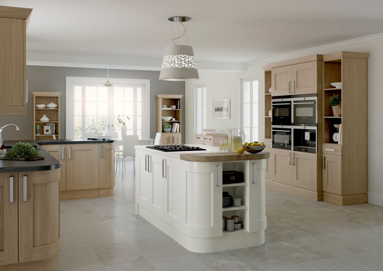 A cream shaker kitchen with a curved island and pendant lights