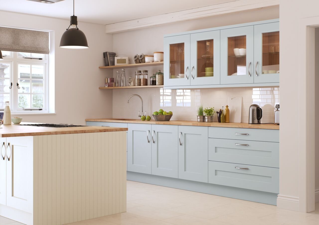 A pale blue shaker kitchen with solid timber worktops and open shelving