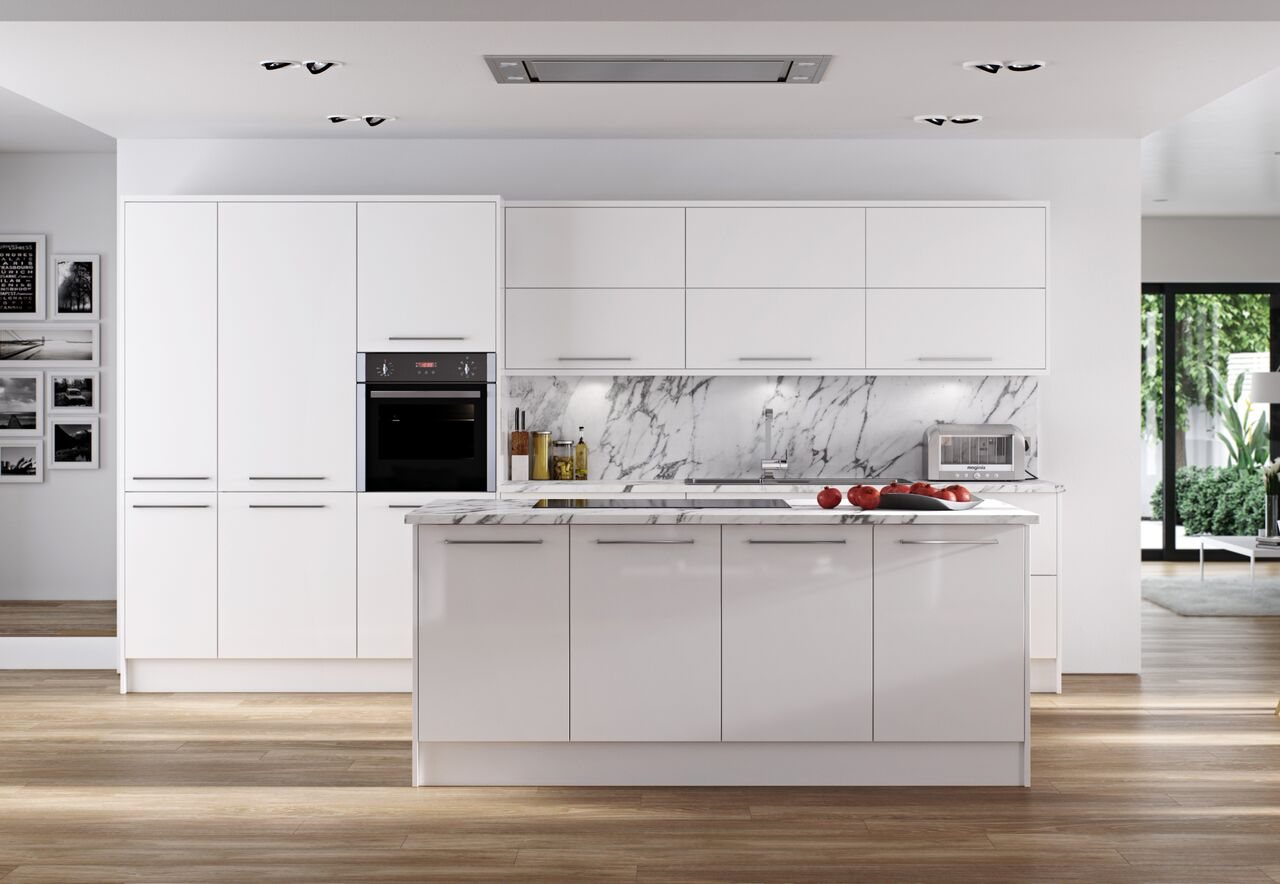 A white kitchen with a large island and integrated ovens