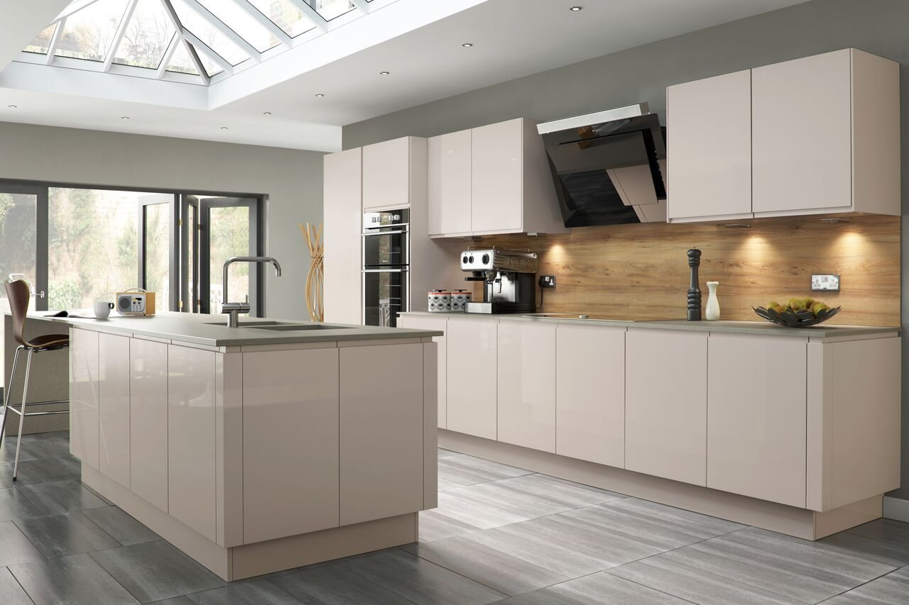 A white kitchen with solid timber worktops and a window over the sink