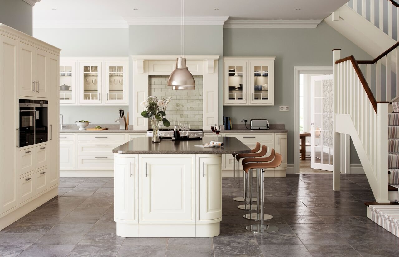 A cream in-frame kitchen with a central island and dark granite worktops